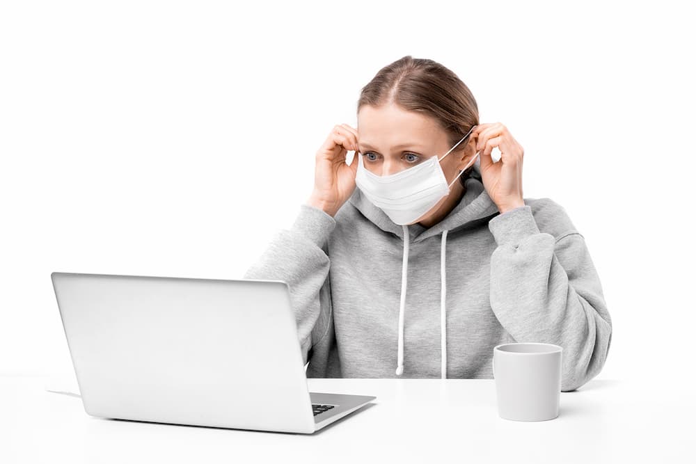 woman deleting files with mask on