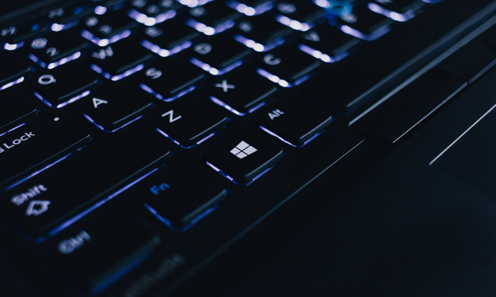 Black keyboard lighting up in the dark