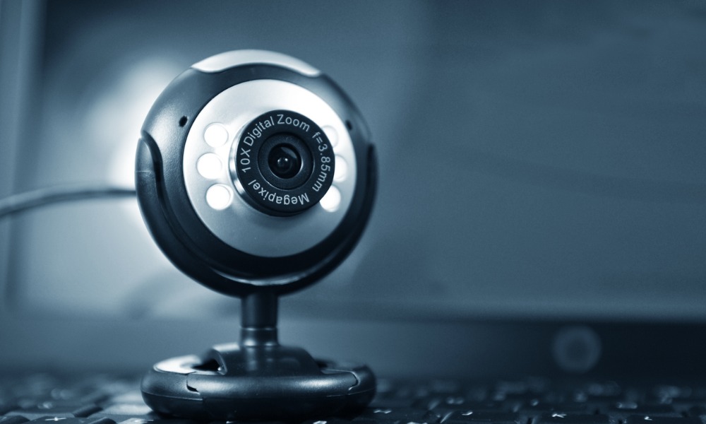 A picture of a webcam sitting on a keyboard. These devices are vulnerable to hacking without proper webcam security.